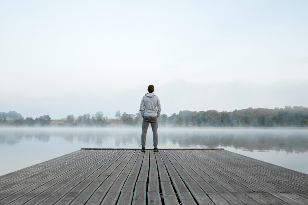 man standing alone on a dock