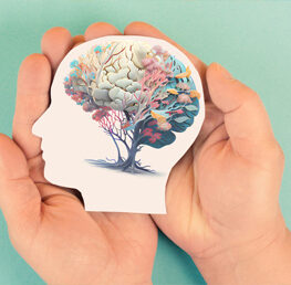hands holding paper illustration of colorful mind