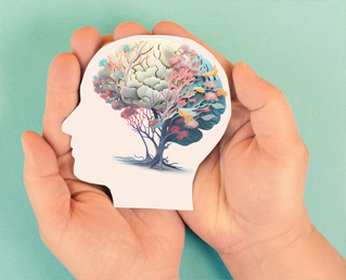 hands holding paper illustration of colorful mind